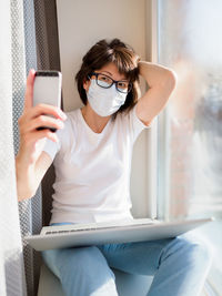 Midsection of man using mobile phone
