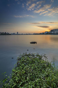 Scenic view of lake against sky during sunset