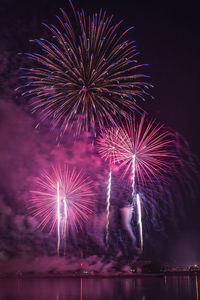 Low angle view of firework display at night