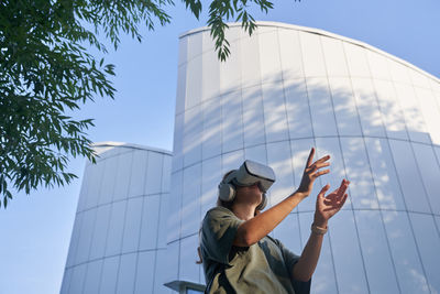 Low angle view of man standing against sky