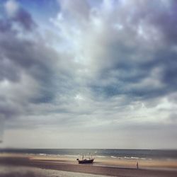 Scenic view of sea against cloudy sky