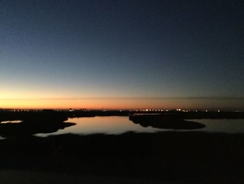 Scenic view of sea against clear sky during sunset