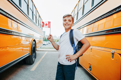 Portrait of smiling young man standing on bus