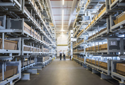 Two men walking in factory warehouse