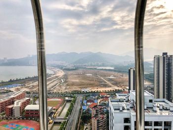 Aerial view of cityscape against sky