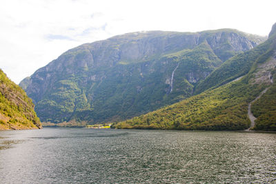 Scenic view of lake and mountains against sky