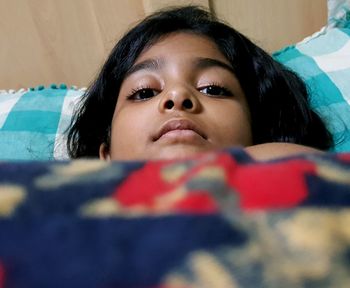 Portrait of girl relaxing on bed at home