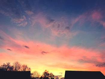 Low angle view of silhouette trees against sky during sunset