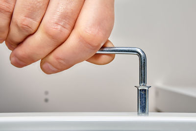 Close-up of hand holding faucet