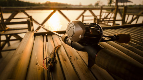 Close-up of a fishing bait casting rod and reel on lake