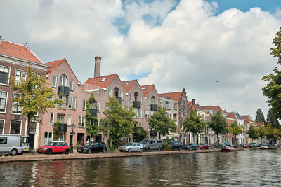 Panoramic view of buildings by canal against sky