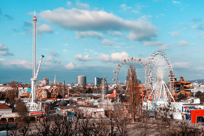 Ferris wheel in city against sky