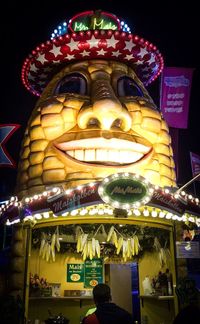 Low angle view of illuminated carousel at amusement park