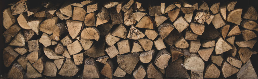 Full frame shot of wooden logs in forest