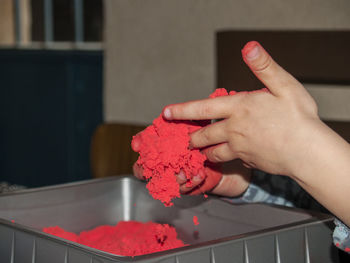 Cropped image of hands holding powder paint