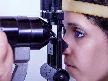 Close-up of young woman holding camera