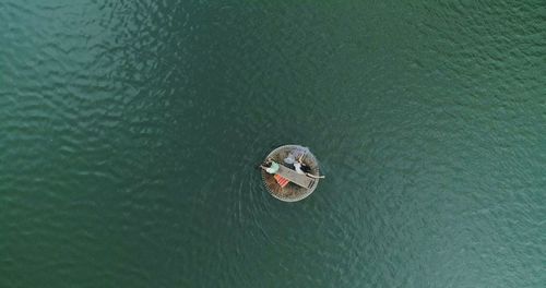 Aerial view of man and woman on raft in sea