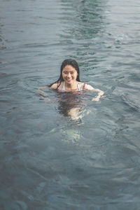 Portrait of a young woman swimming in pool