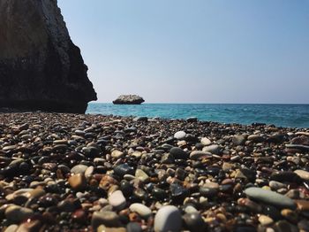 Close-up of pebbles by sea at beach