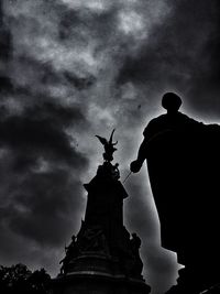 Low angle view of eiffel tower against cloudy sky