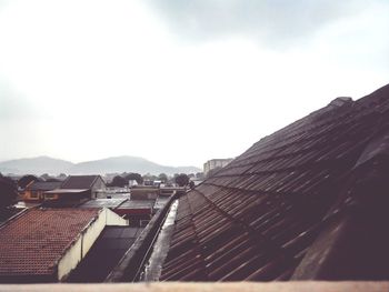 Houses against mountain range