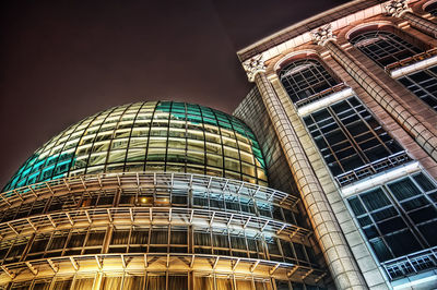 Low angle view of illuminated building against sky at night