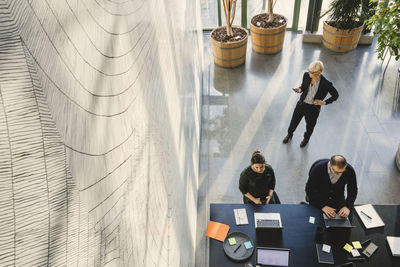 High angle view of business people working at creative office