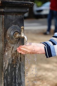 Close-up of hand holding water fountain