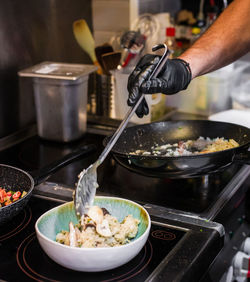 Cropped hand of man preparing food