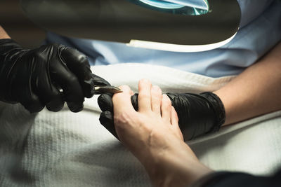 Pedicure female medical close-up using pliers