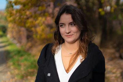 Portrait of smiling woman standing outdoors