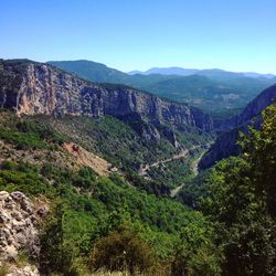 Scenic view of mountains against clear blue sky