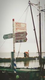 Information sign on calm sea against the sky