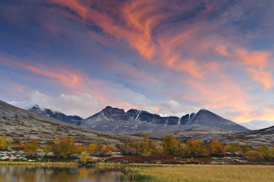 Sunset over rondslottet mountain in rondane national park, norway, europe