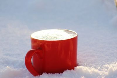 Close-up of ice cream against sky during winter