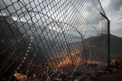 Chainlink fence against sky