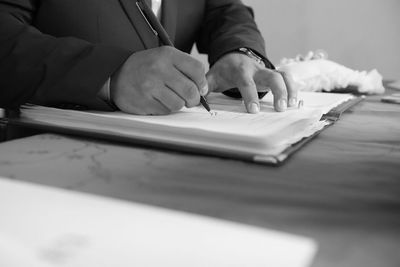 Midsection of woman working on table