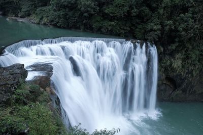 Scenic view of waterfall in forest