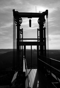 Silhouette bridge against sky at sunset