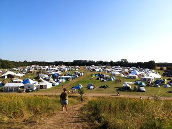 Festival camp view of field against clear sky