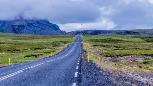 Road passing through landscape against sky