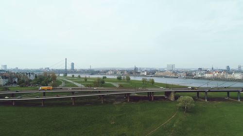 Bridge over river in city against sky