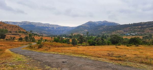 Scenic view of landscape and mountains against sky