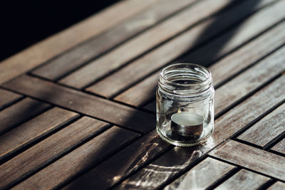 High angle view of lid in jar on wooden table