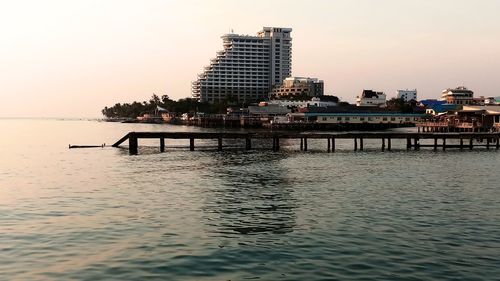 Pier by sea against sky during sunset