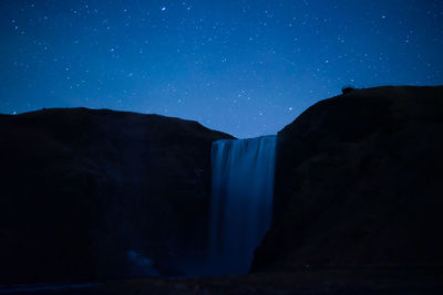 Scenic view of silhouette mountain against sky at night