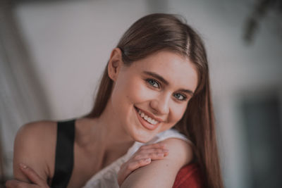 Portrait of a smiling young woman at home