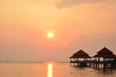 Scenic view of sea against orange sky