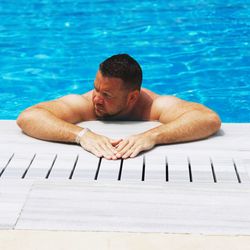 Portrait of man swimming in pool