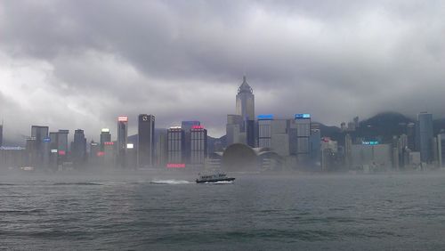 View of skyscrapers against cloudy sky